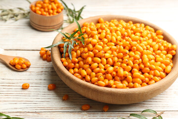 Fresh ripe sea buckthorn on white wooden table