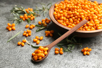 Fresh ripe sea buckthorn on grey table