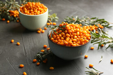 Fresh ripe sea buckthorn on grey table