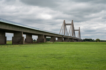 Tiel, Gelderland, The Netherlands, Concrete suspension bridge of the A15 highway surrounded by green meadows