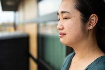 Portrait of a 32 year old Japanese woman, thinking eyes closed