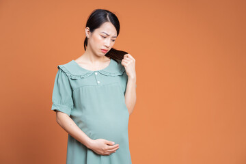 Obraz premium Photo of Asian pregnant woman on background