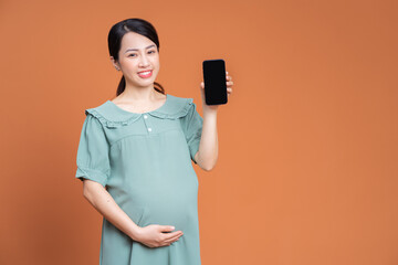 Photo of Asian pregnant woman on background