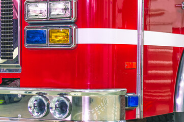 A special sound signal of a fire truck. View of the fire truck from the front. Shiny chrome fire truck parts. Fire truck headlights. The front part of the cab of the fire truck headlights.