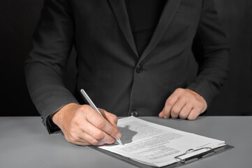 Signing contract, business agreement and deal concept. Closeup businessman reading before signing business contract documents