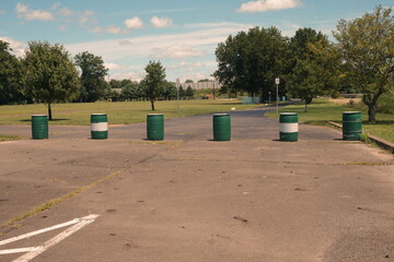 Road Block with Six Green and White Barrels in Daylight