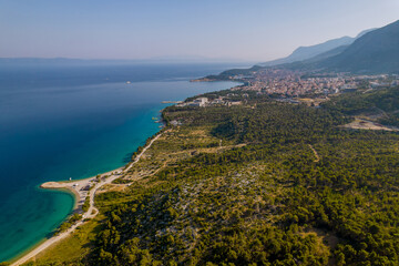 Aerial view of a resort town by the sea and a pine forest in Croatia.