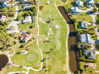 Aerial View of Houses on Golf Course In Florida with swimming pool