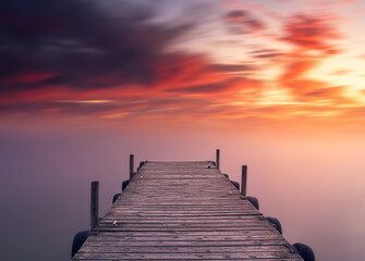 Fototapeta premium Beautiful landscape and colorful sunset view from the shore with a wooden pier, Albufera, Valencia