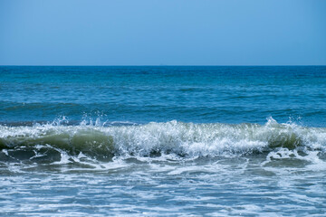 Fototapeta premium Ocean waves crashing on sandy beach. Sea waves breaking on Maditerranean's shore.