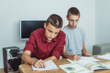 Naklejka premium school boys in classroom at lesson 