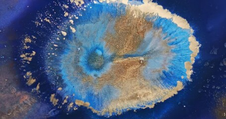 Blue gold paints abstract explosion. Blue-gold sparkles splash liquid ink. Bright blue color spreading, moving background. 4k footage. Golden glitter flowing on fluid texture. Colorful vertical video