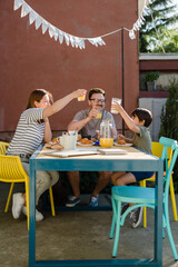 family have breakfast outdoor in backyard at home
