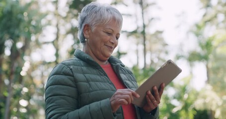 Communication, tablet and senior woman texting a message at the park and browsing social media or doing an online search. Female watching content on the internet or sending sms on mobile app outside