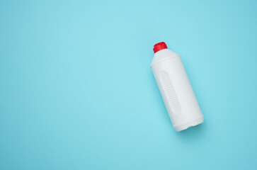 White plastic bottle for liquid on a blue background, top view