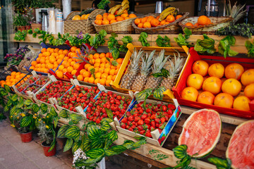 Fototapeta na wymiar Fruit market counter with assortment of fresh fruits for sale