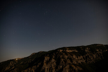 night sky with stars over a deep gorge in the mountains of Armenia