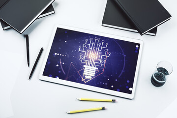 Creative light bulb illustration with microcircuit on modern digital tablet display, future technology concept. Top view. 3D Rendering