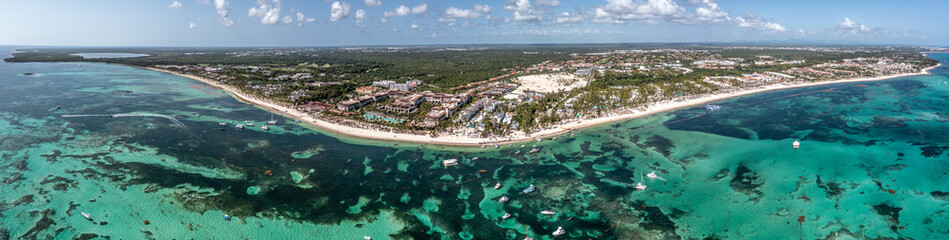 Punta Cana, Dominican Republic , panoramic aerial view around the area of Bávaro Beach with azure water, beach and tourist attractions - bird eyes view 