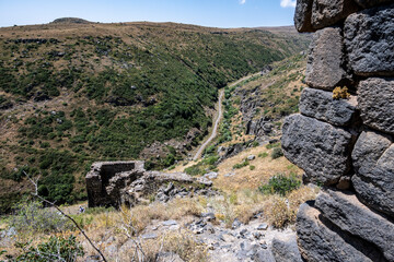 ancient stone dilapidated fortress in a picturesque place in the mountains of Armenia