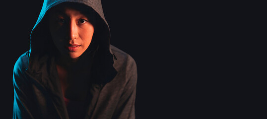 asian adult female sport woman in jacket hood cloth look at camera studio shot dark background,asian female wearing sport hood cloth portrait prepare to workout concept close up