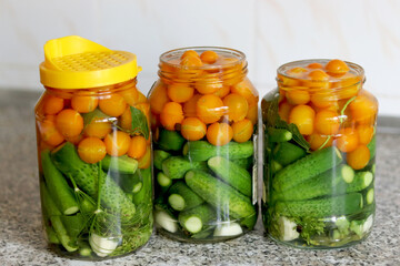 The process of preserving cucumbers and tomatoes for the winter. selective focus