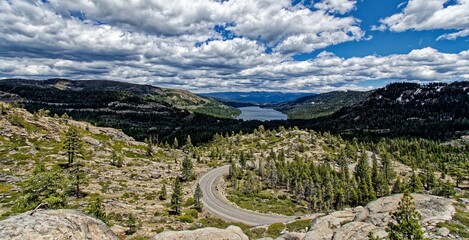 Lake Tahoe in the background of the rocky mountains covered in forests