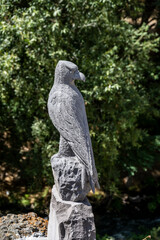 Obraz premium stone falcon on a green background as a symbol of mountains in Armenia