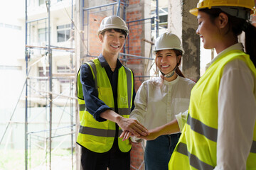 Structural engineer and architect discussing and working with blueprints at the outdoors construction site