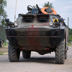 COMBAT RECONNAISSANCE/PATROL VEHICLE - A camouflage scout on a country road
