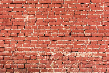 Solid background of red bright bricks in sunny weather. Bright brick wall background