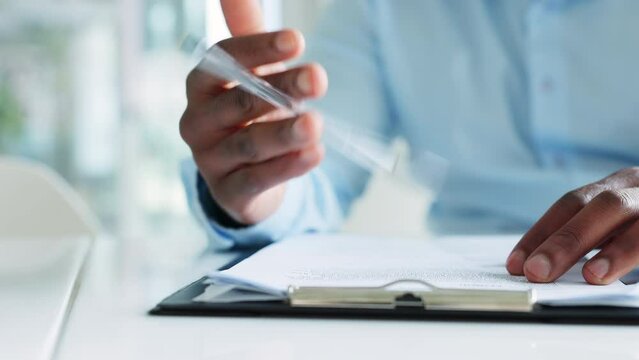 Anxious business man reading contract or form, waiting before signing document. Closeup of nervous male hands thinking or contemplating decision and writing on paperwork, tapping pen on clip board.