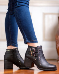 woman's legs wearing leather fashion shoes of different casual and dress styles in assorted colors