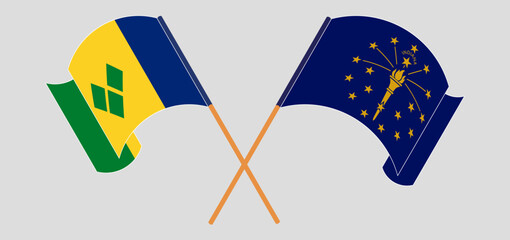 Crossed and waving flags of Saint Vincent and the Grenadines and the State of Indiana