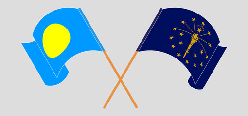 Crossed and waving flags of Palau and the State of Indiana