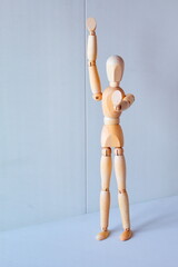 Concept of making the stop signal with the figure of a wooden boy