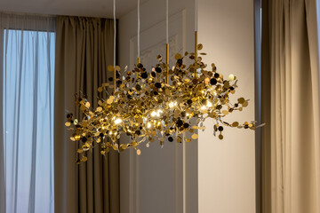 Designer gold chandelier. Luxurious crystal chandelier on the ceiling. bottom view. close-up. Huge crystal gold chandelier.