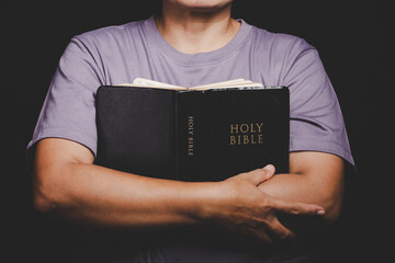 Close up of christian woman hand holding holy bible pray and worship for thank god in church with...