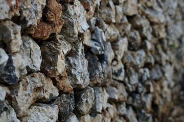 selective focus of the arrangement of stones on the fence