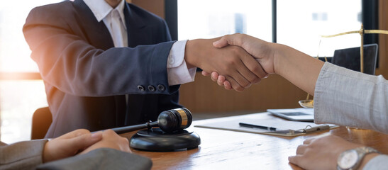 Fototapeta na wymiar Businessman shaking hands to seal a deal with his partner lawyers or attorneys discussing a contract agreement.