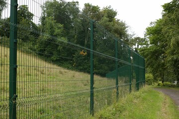 Closeup of an area isolated by a green wire fence in the park