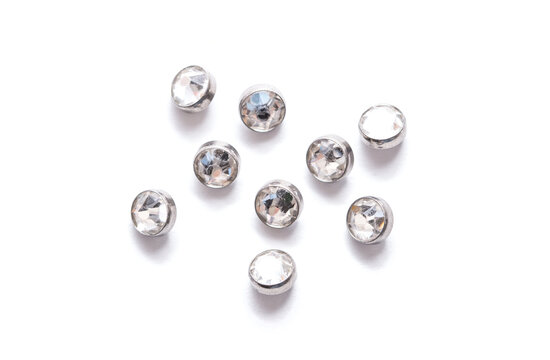A set of jewelry for piercing on a white background. A set of earrings for the body, nose, navel, tongue, nipples, ears, various beauty jewelry, a set of cosmetological jewelry for piercing.