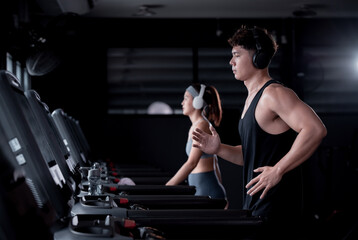 Young Fitness sport people wearing sportwear with workout headband under exercise on treadmill machine gym is sport healthy body building in fitness lifestyle.