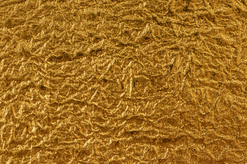 金色の壁紙のざらざらした粗い表面