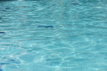 Selective focus of clear water reflection in the swimming pool