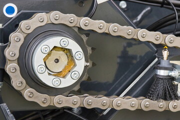 Metal chain and gear as part of agricultural and industrial machine. Technology