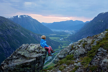 Family with children and dog, hiking in Litlefjellet on sunset, enjoying amazing view from the top...