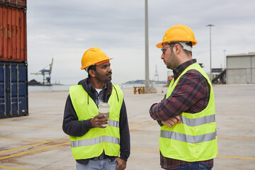 Multiethnic men talking together while standing on a commercial dock