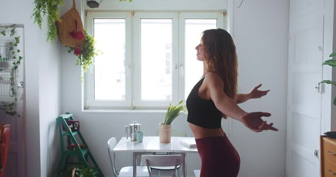Woman practicing yoga at home with arms doing Garudasana. Gimbal