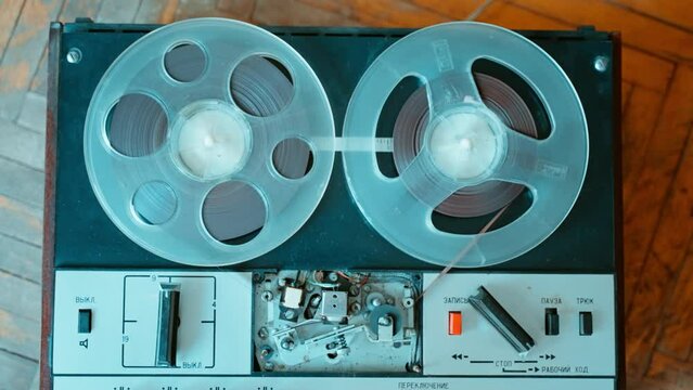 Turning off an old reel to reel tape recorder that was turned on for playback.